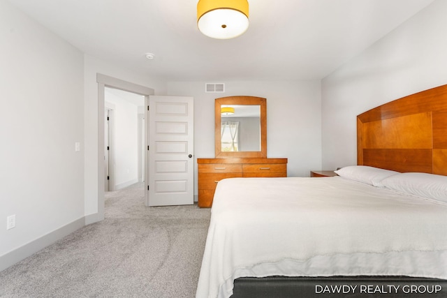 unfurnished bedroom featuring light carpet, visible vents, and baseboards