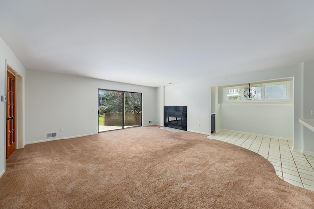 21082 Boulder Cir, Northville, MI 48167 - unfurnished living room with baseboards, tile patterned floors, carpet floors, visible vents, and a tiled fireplace