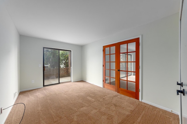 21082 Boulder Cir, Northville, MI 48167 - empty room featuring french doors, carpet floors, and baseboards