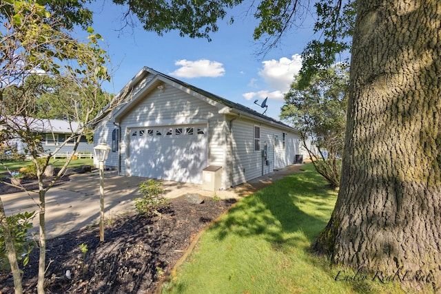 view of side of home featuring a garage and a yard