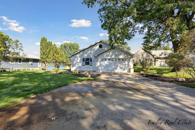 view of front facade featuring an attached garage, driveway, and a front yard