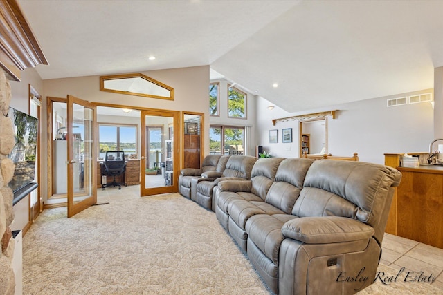 living room featuring high vaulted ceiling, recessed lighting, french doors, and visible vents