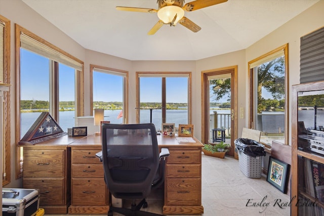 office with a ceiling fan, a water view, and plenty of natural light