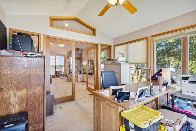 office area with ceiling fan, vaulted ceiling, and light tile patterned flooring