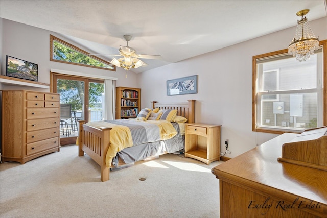 carpeted bedroom featuring vaulted ceiling, access to outside, and ceiling fan with notable chandelier