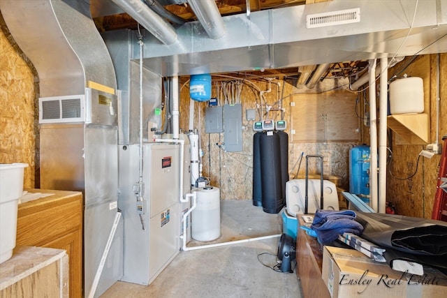 utility room featuring electric panel and visible vents