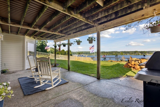 view of patio / terrace featuring a water view, a grill, and fence