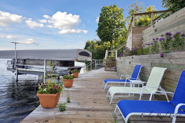 exterior space with a water view, boat lift, stairs, and a boat dock