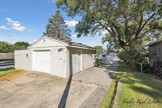 detached garage with concrete driveway