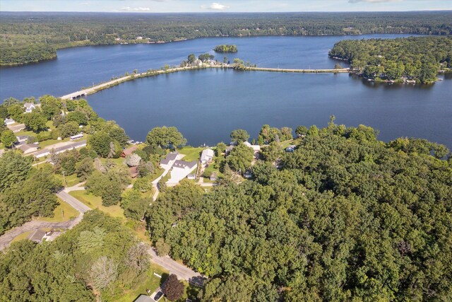 drone / aerial view featuring a water view and a forest view