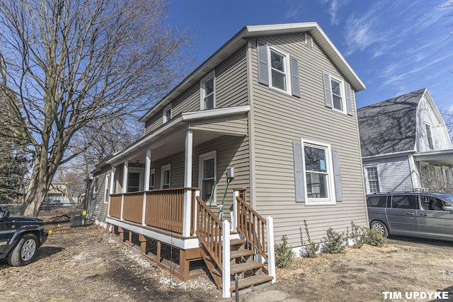 view of front of house with covered porch and central AC unit