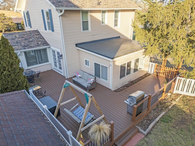 back of property featuring a shingled roof, french doors, fence, and a deck