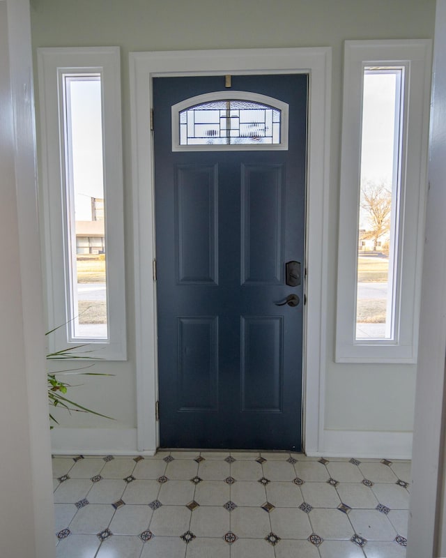 entrance foyer featuring baseboards and tile patterned floors