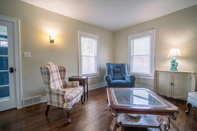 sitting room featuring a healthy amount of sunlight, baseboards, visible vents, and wood finished floors