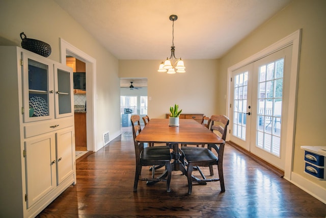 dining space featuring a healthy amount of sunlight, dark wood-style flooring, and french doors