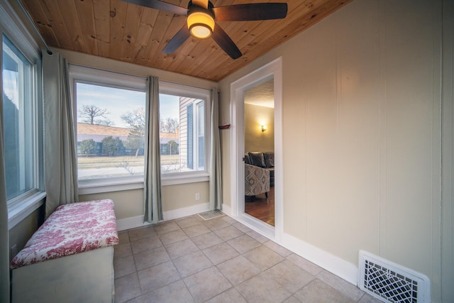 entryway with light tile patterned flooring, wooden ceiling, visible vents, baseboards, and a ceiling fan