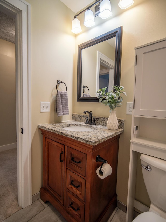 half bathroom with vanity and toilet