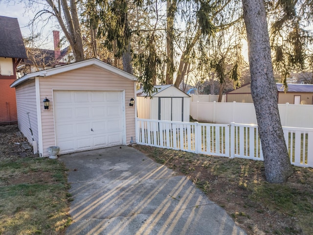 detached garage with driveway and fence