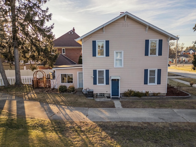 view of front of house featuring cooling unit and fence