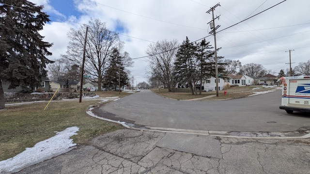 view of street with a residential view and curbs