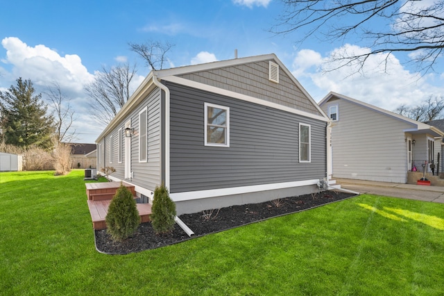 view of property exterior featuring cooling unit and a lawn