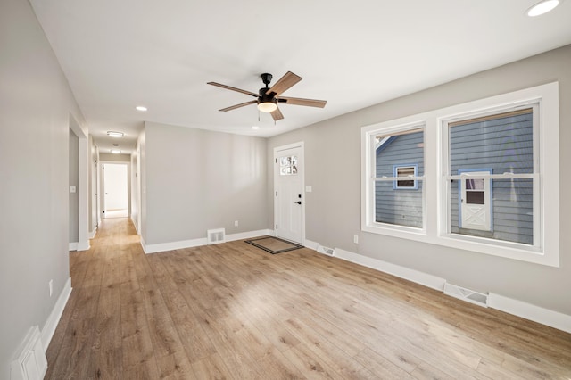 foyer featuring light wood-style flooring, visible vents, and baseboards