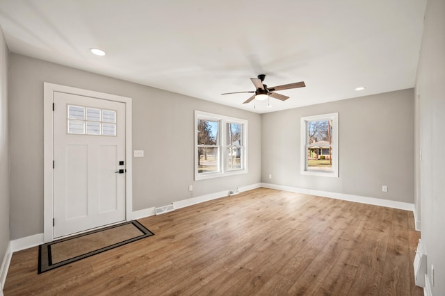 foyer entrance with visible vents, baseboards, wood finished floors, and recessed lighting