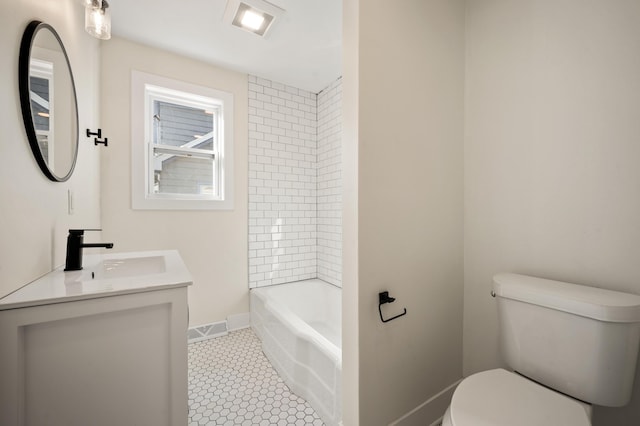 bathroom featuring toilet, vanity, visible vents, baseboards, and tile patterned floors