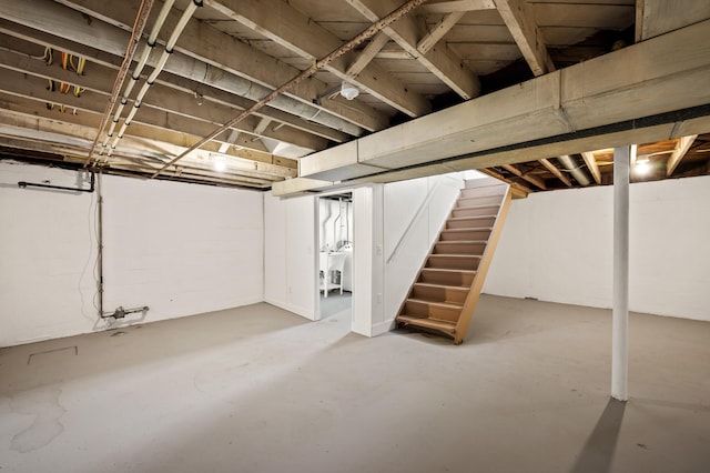 unfinished basement featuring stairs