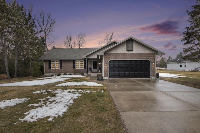 view of front of home featuring concrete driveway, brick siding, and an attached garage