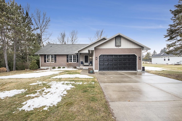 view of front of property featuring a garage, driveway, and brick siding