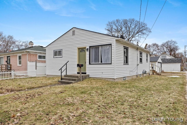 back of property with a yard and fence