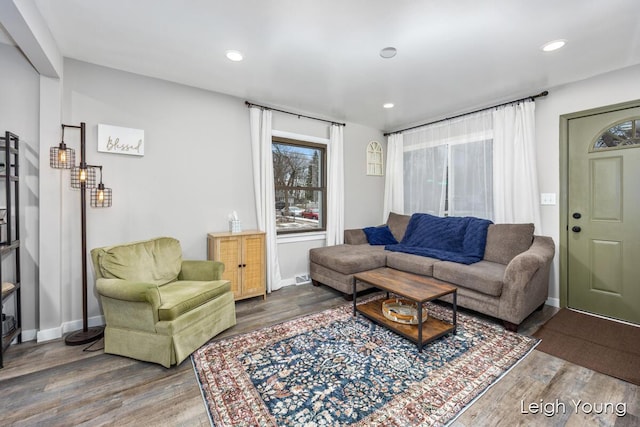 living area with recessed lighting, baseboards, and wood finished floors