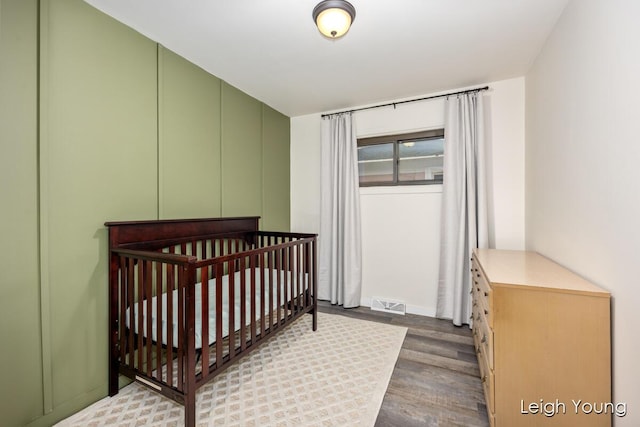 bedroom with visible vents and wood finished floors