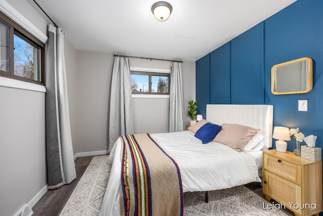 bedroom featuring visible vents, dark wood-type flooring, and baseboards