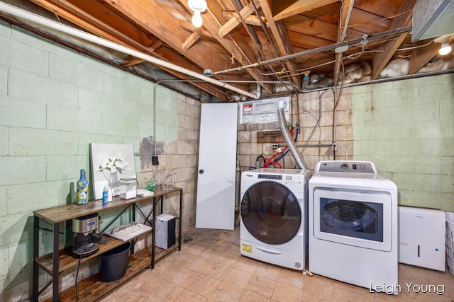 clothes washing area featuring washer and dryer and laundry area