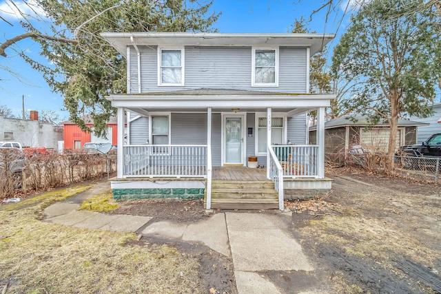 view of front of house featuring a porch and fence