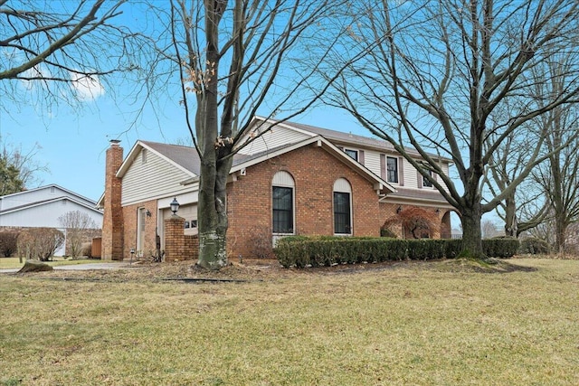 view of side of home featuring a garage, brick siding, and a lawn