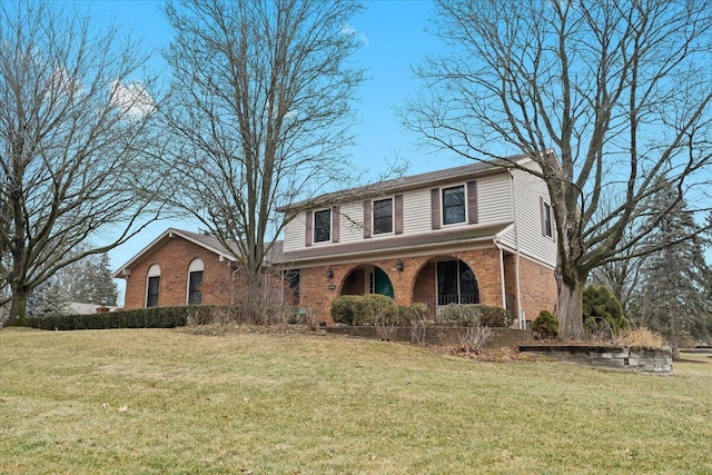 traditional-style house featuring brick siding and a front yard