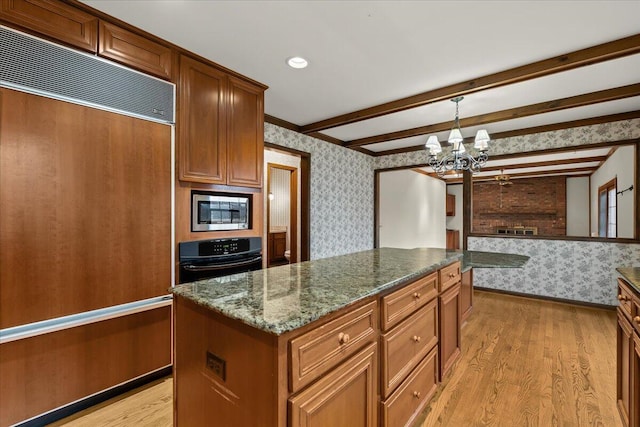 kitchen featuring light wood-type flooring, wallpapered walls, beamed ceiling, and built in appliances
