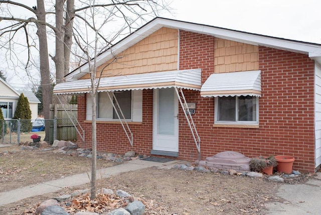 view of front of property with fence and brick siding