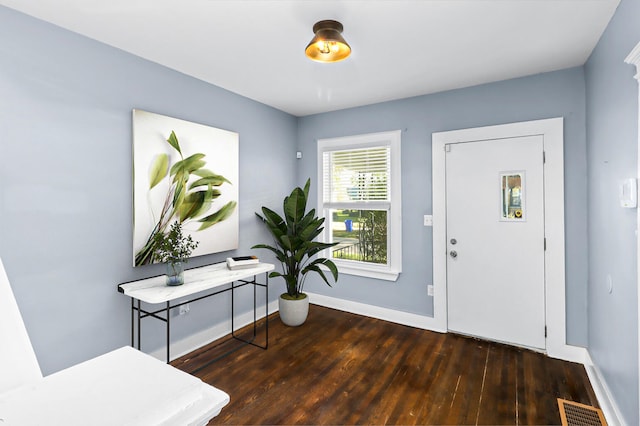 entryway with baseboards, visible vents, and wood finished floors