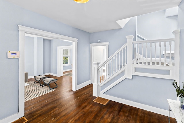 stairs featuring baseboards and wood finished floors