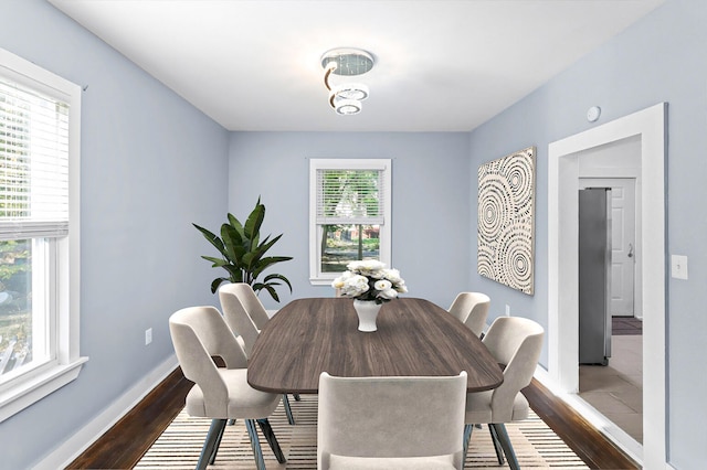 dining area with wood finished floors and baseboards