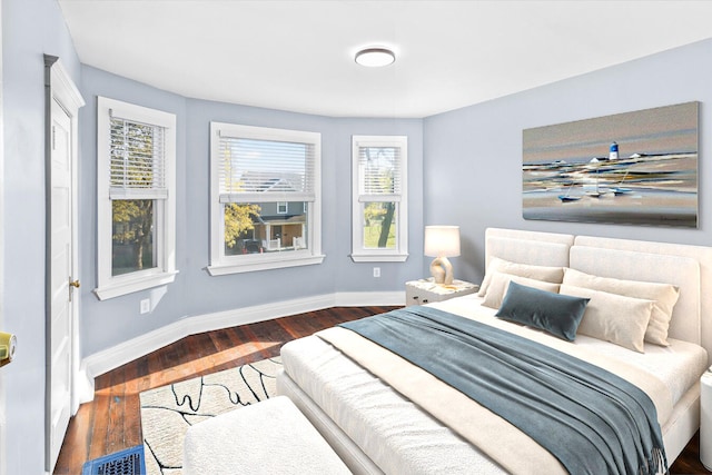 bedroom featuring dark wood-type flooring and baseboards