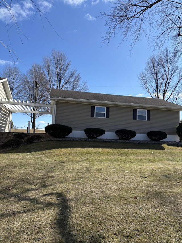 view of property exterior featuring a lawn and a pergola