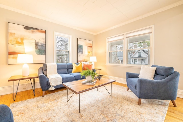 living area with ornamental molding, baseboards, and wood finished floors