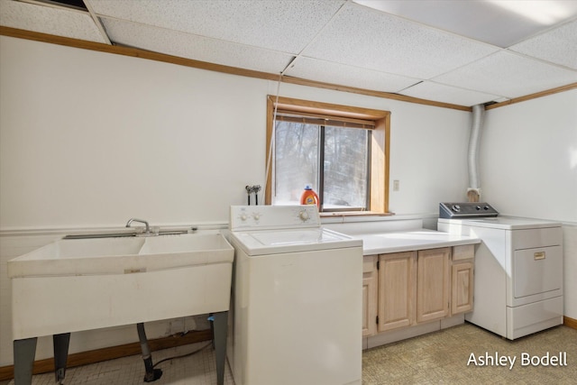 clothes washing area featuring washer and dryer, cabinet space, and light floors