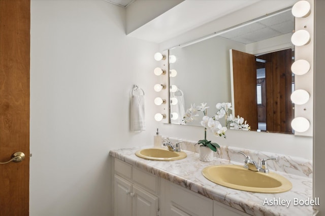 full bath with a sink and double vanity