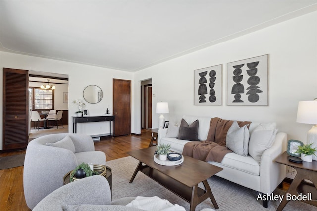 living room with an inviting chandelier and wood finished floors